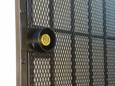 A black installed door with vertical support reinforced and door lock secured.