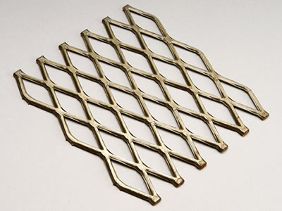 There is a small panel of golden coated expanded mesh flattened.