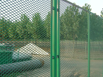 The picture shows green security fence of one factory, and the fence is made of raised expanded metal and metal posts.
