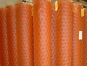 There are many rolls of steel expanded metal that are painted red.
