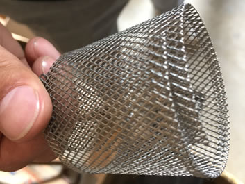 One piece of raised expanded metal sheet is welded into cylinder shape.